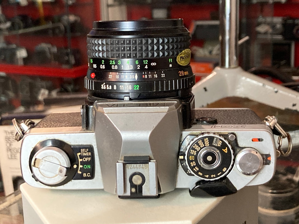 Bovenaanzicht en bediening van de Minolta XG-1